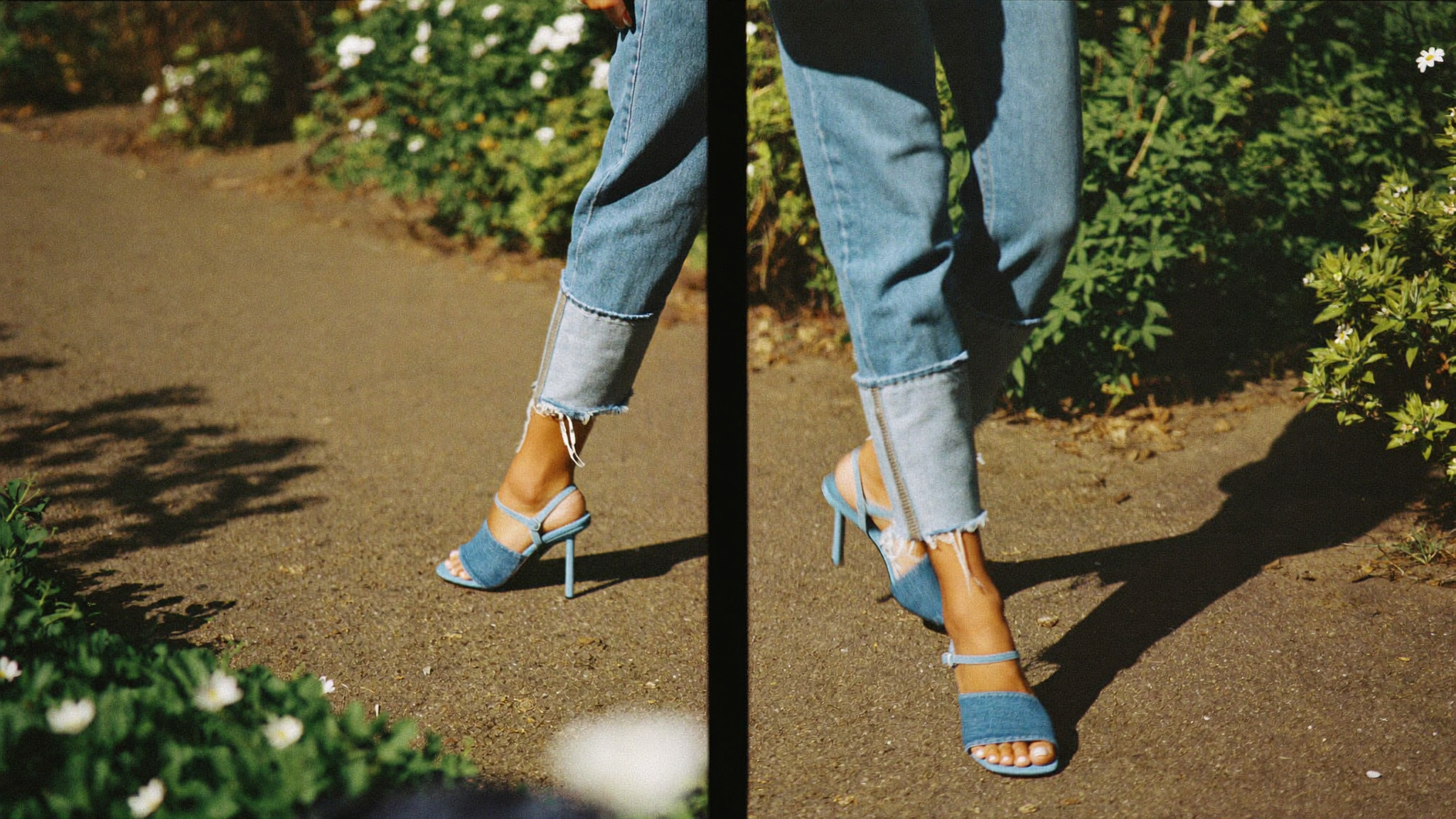 Denim wedge sandals styled with cropped jeans on a sunlit garden path