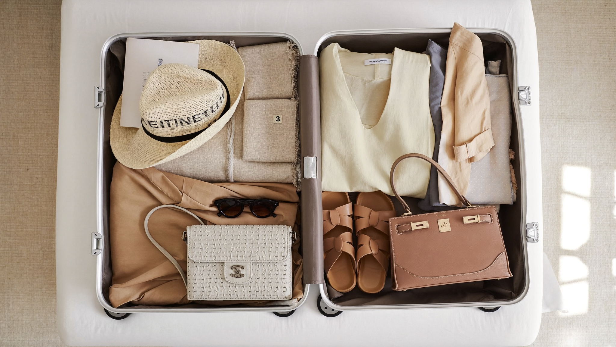 Summer holiday capsule wardrobe packed neatly into a carry-on suitcase
