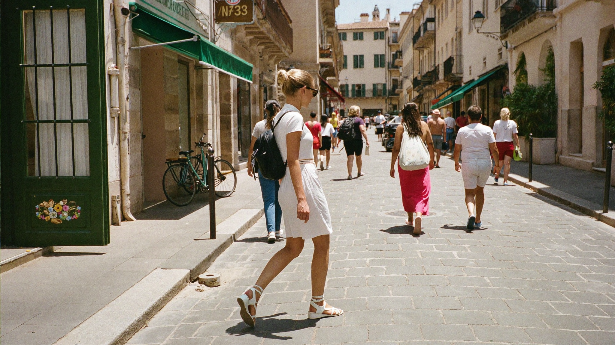 Woman in comfortable walking sandals exploring a cobbled old-town street on holiday